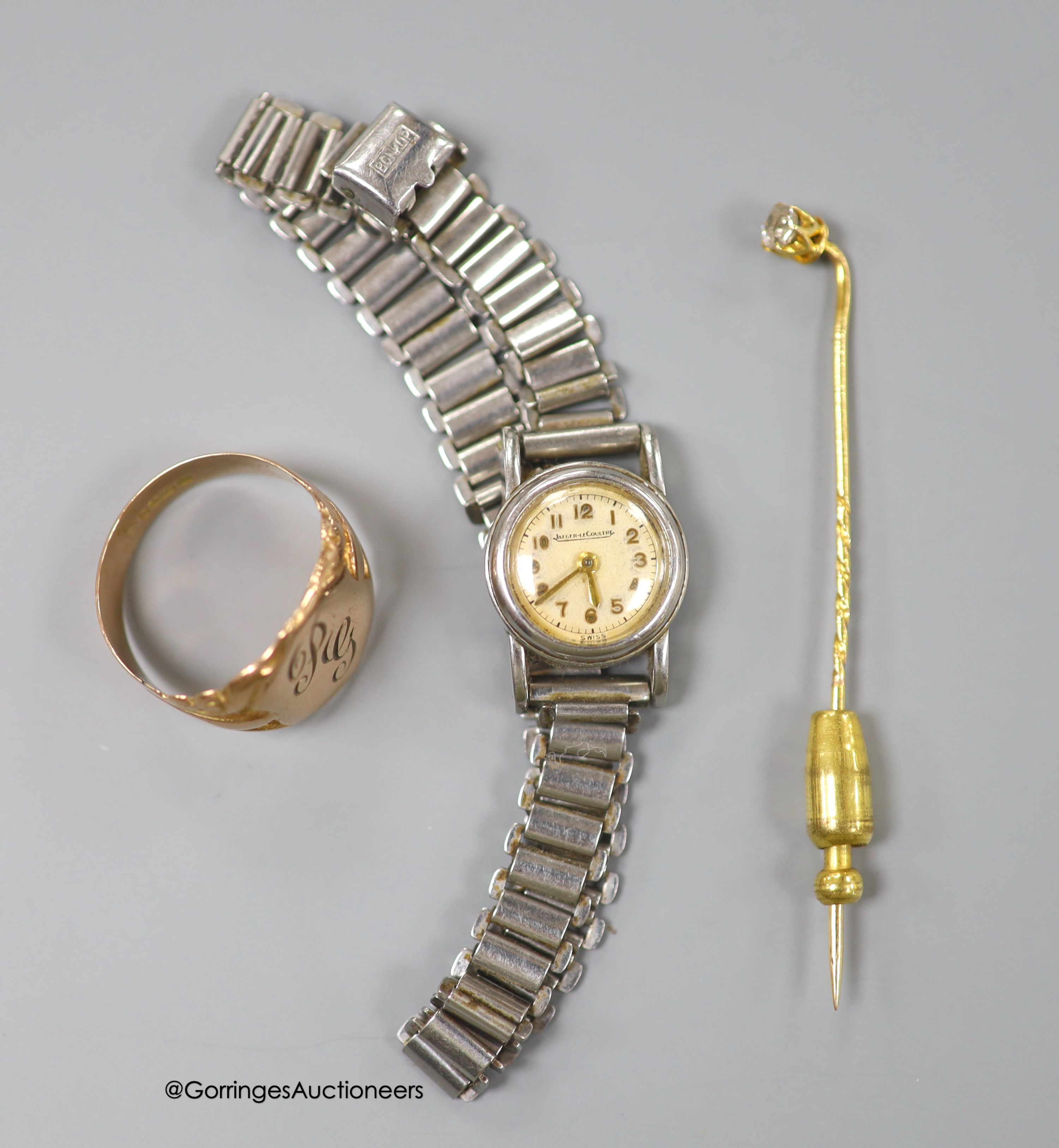 A 9ct gold signet ring, size S, 4.1 grams, a yellow metal and diamond set stick pin and a lady's stainless steel Jaeger LeCoultre back wind wrist watch, on steel bracelet.